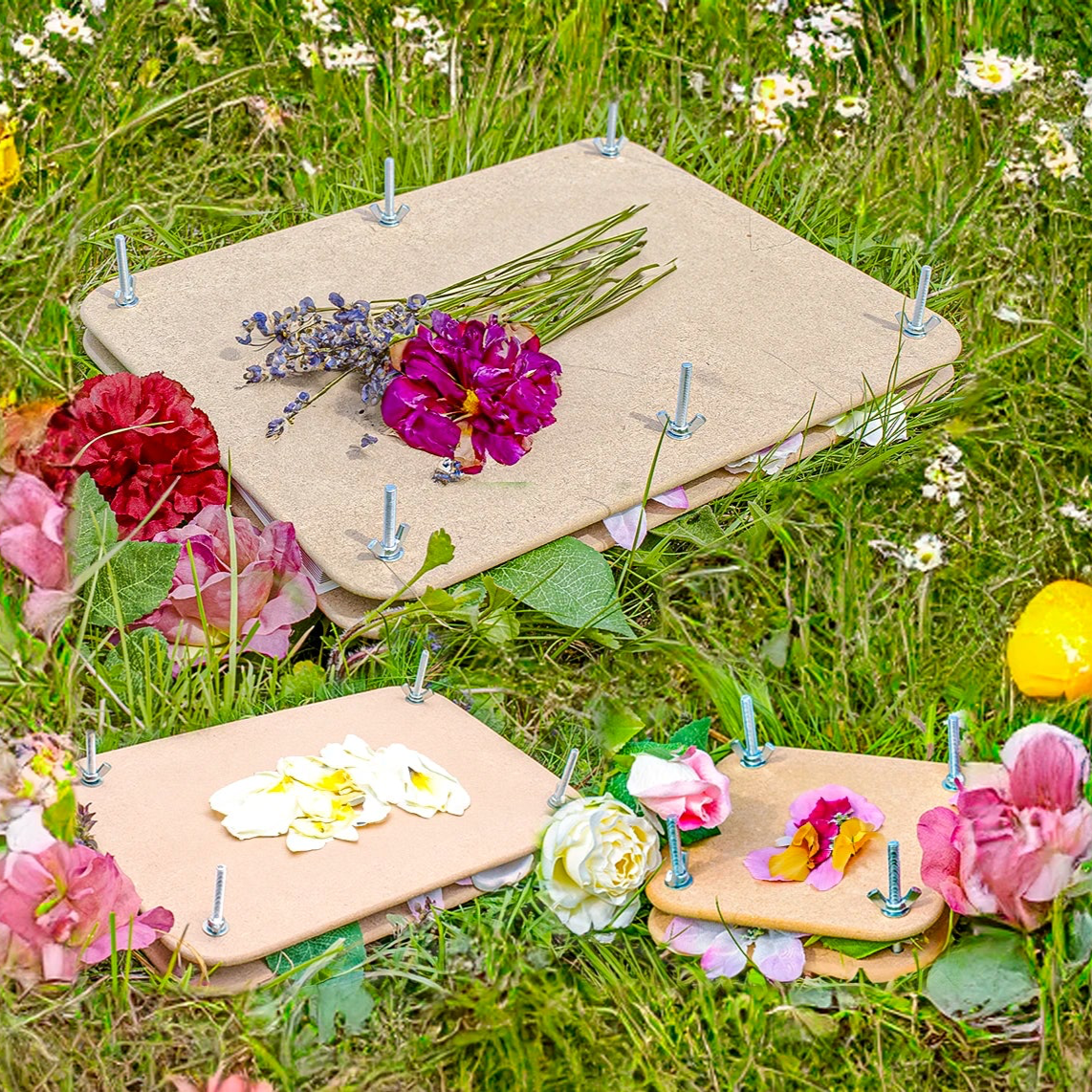 Floral arrangements on Flower Presses with nails in a grassy field