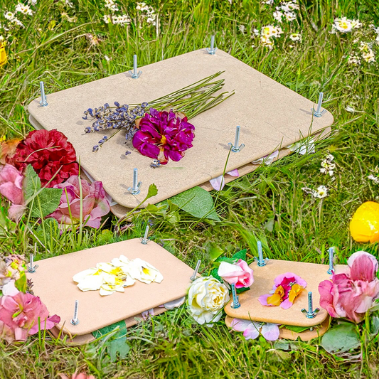 Floral arrangements on Flower Presses with nails in a grassy field